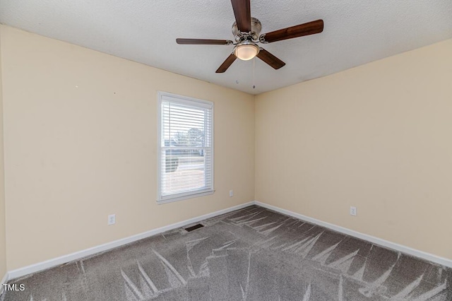 carpeted spare room featuring baseboards, visible vents, and a textured ceiling