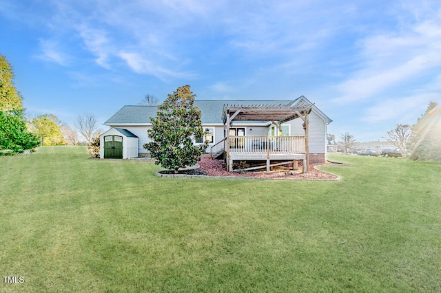 back of house featuring a storage shed, a yard, an outbuilding, and a pergola