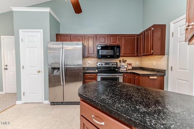 kitchen with decorative backsplash, a high ceiling, appliances with stainless steel finishes, and ceiling fan