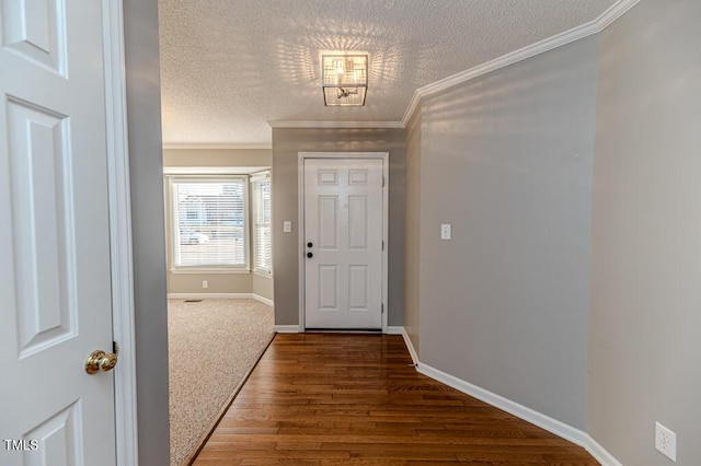 doorway to outside with baseboards, a textured ceiling, ornamental molding, and dark wood finished floors