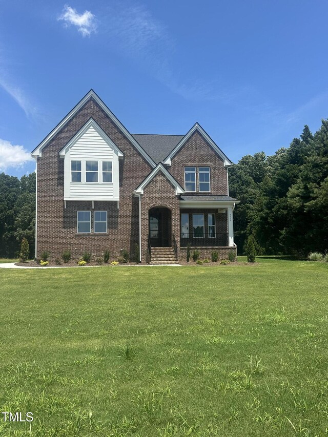 9000 Penny Rd, Raleigh, NC 27606 - view of front of property featuring brick siding, a front lawn, and a porch