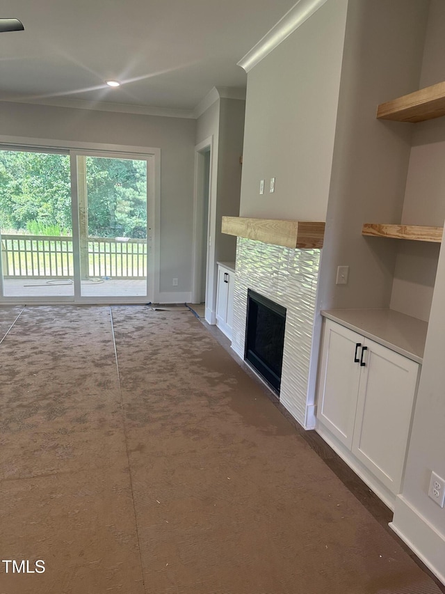 9000 Penny Rd, Raleigh, NC 27606 - unfurnished living room with crown molding, carpet floors, and a tile fireplace