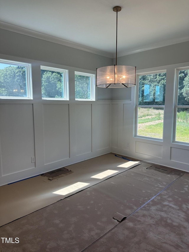 9000 Penny Rd, Raleigh, NC 27606 - unfurnished dining area with a decorative wall, ornamental molding, and wainscoting