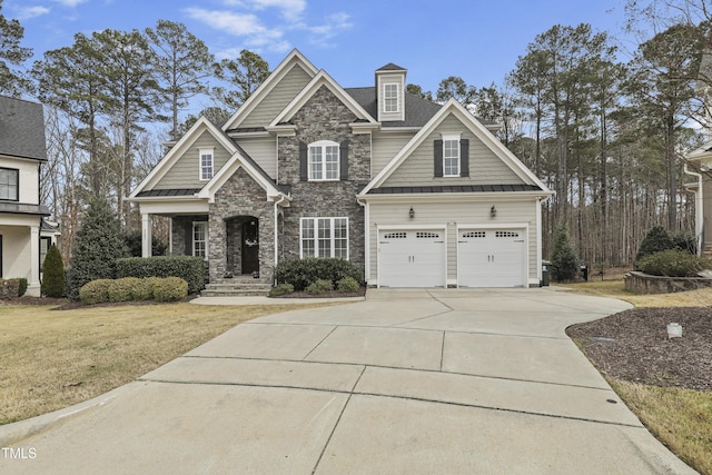 craftsman-style home featuring a front lawn, a standing seam roof, stone siding, concrete driveway, and metal roof