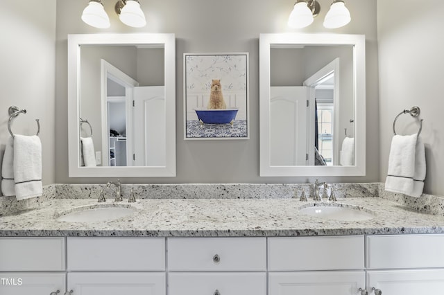 bathroom featuring double vanity and a sink