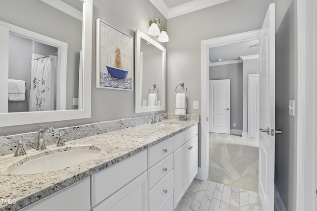 bathroom with a sink, ornamental molding, and double vanity