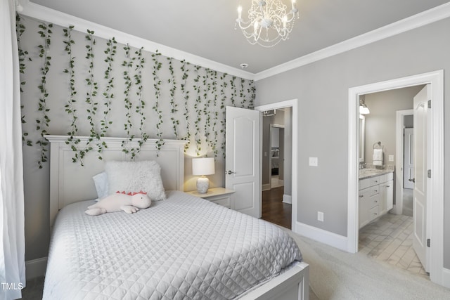 bedroom with baseboards, ornamental molding, ensuite bathroom, light colored carpet, and a chandelier