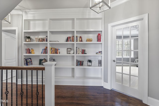 interior space featuring built in features and wood finished floors