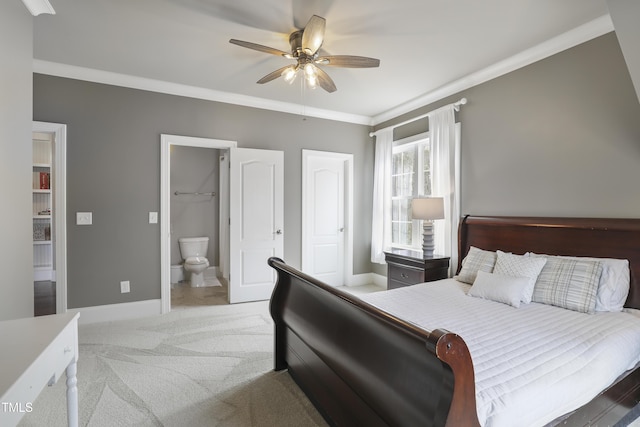 bedroom featuring light colored carpet, ensuite bathroom, baseboards, and ornamental molding