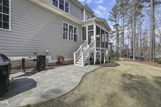 back of house with a patio, a yard, a sunroom, stairs, and crawl space