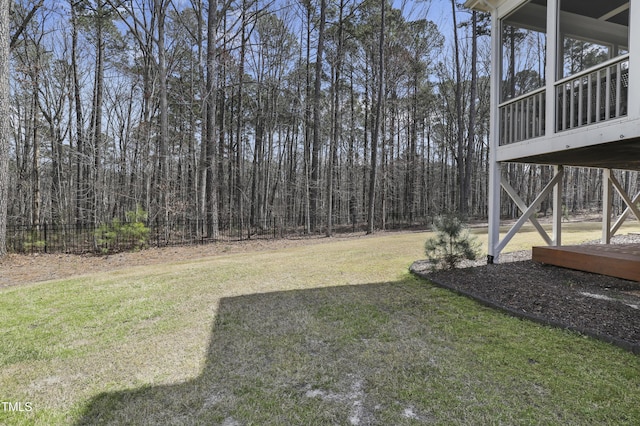 view of yard featuring fence and a view of trees