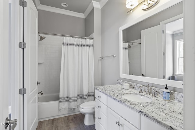 bathroom with vanity, toilet, wood finished floors, and ornamental molding