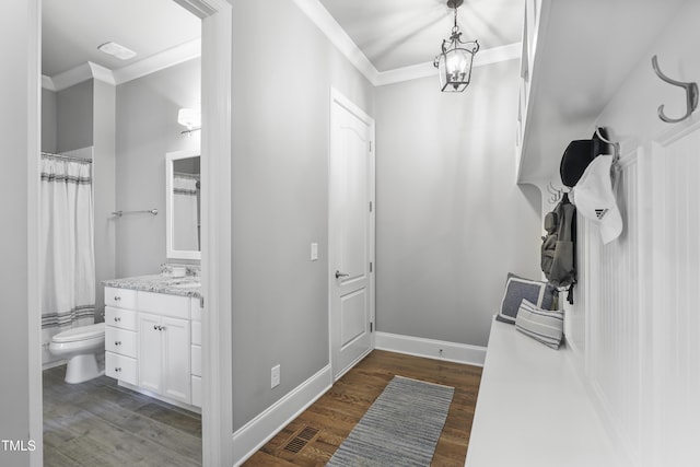 interior space featuring visible vents, toilet, crown molding, and wood finished floors