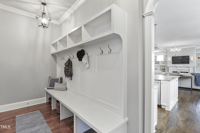 mudroom with baseboards, decorative columns, dark wood-style flooring, ornamental molding, and a chandelier