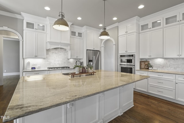 kitchen featuring a spacious island, recessed lighting, white cabinets, stainless steel appliances, and dark wood-style flooring