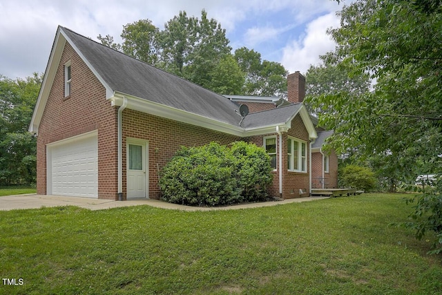 view of home's exterior featuring concrete driveway, a yard, brick siding, and a chimney