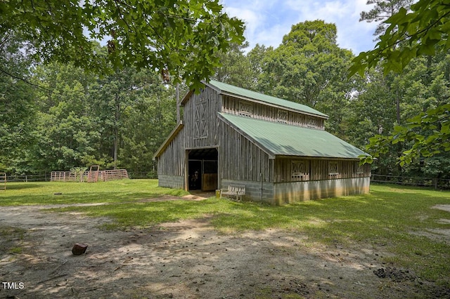 view of barn with fence