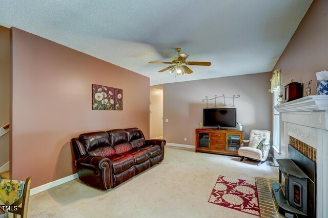 living room with baseboards, a ceiling fan, lofted ceiling, and carpet flooring