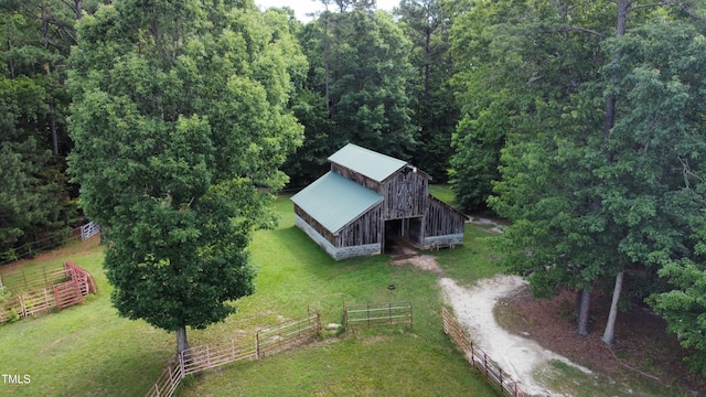 birds eye view of property featuring a view of trees