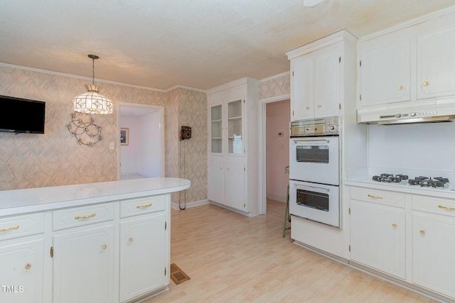 kitchen featuring light wood-type flooring, white cabinetry, white appliances, crown molding, and light countertops