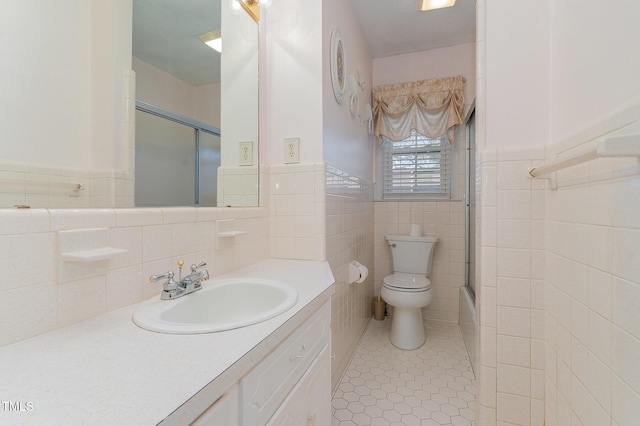 bathroom featuring vanity, tile patterned floors, toilet, and wainscoting