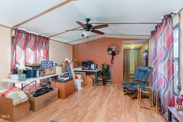 interior space featuring ceiling fan, wood finished floors, and vaulted ceiling