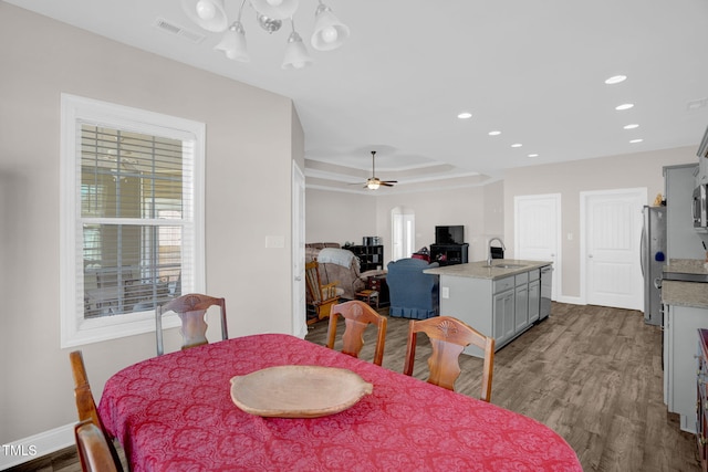 dining room featuring a wealth of natural light, visible vents, dark wood finished floors, and a ceiling fan