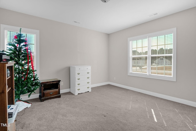 bedroom featuring visible vents, baseboards, and carpet