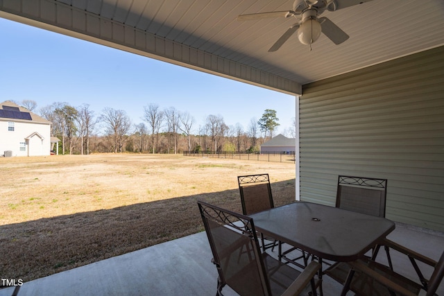 view of patio / terrace with outdoor dining area, a ceiling fan, and fence