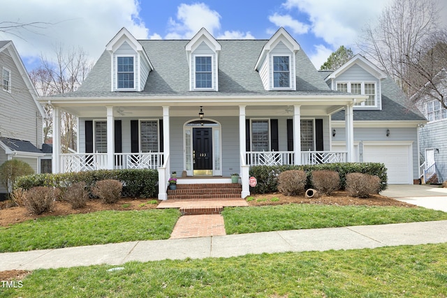 cape cod-style house with an attached garage, a porch, driveway, and a shingled roof