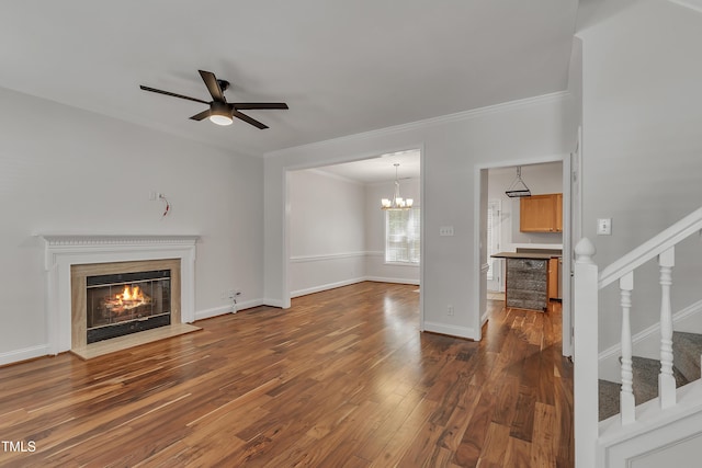 unfurnished living room featuring stairway, baseboards, dark wood-style flooring, a glass covered fireplace, and ceiling fan with notable chandelier