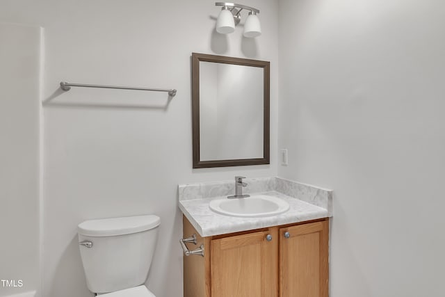 half bathroom featuring toilet and vanity