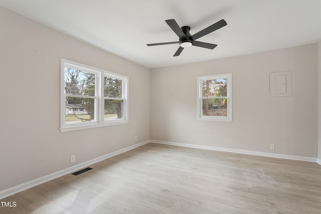 empty room with a ceiling fan, a healthy amount of sunlight, visible vents, and baseboards