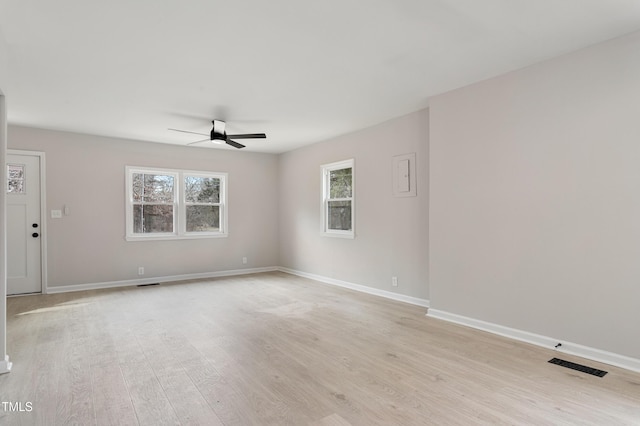 unfurnished living room featuring visible vents, baseboards, light wood-style floors, and a ceiling fan