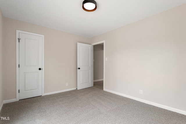 unfurnished bedroom featuring baseboards and carpet