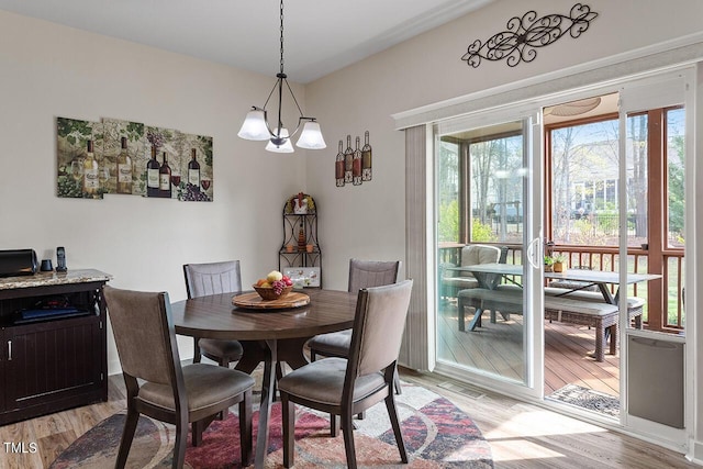 dining room with light wood-type flooring and plenty of natural light