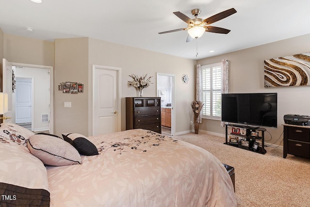 bedroom featuring visible vents, a ceiling fan, ensuite bathroom, carpet flooring, and baseboards