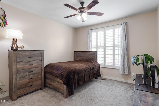 bedroom with light carpet, visible vents, a ceiling fan, and baseboards