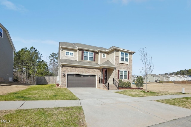 traditional-style home with an attached garage, concrete driveway, a front lawn, and fence