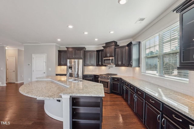 kitchen with a kitchen island with sink, beverage cooler, ornamental molding, dark wood-style floors, and stainless steel appliances