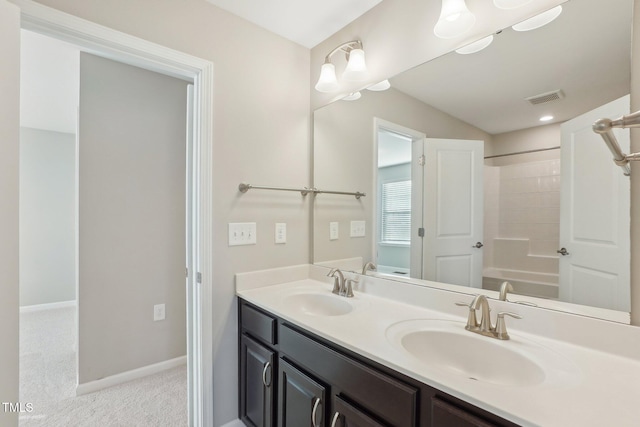 full bath with double vanity, visible vents, baseboards, and a sink