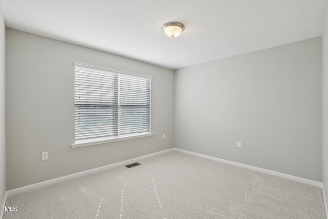 carpeted empty room with baseboards and visible vents