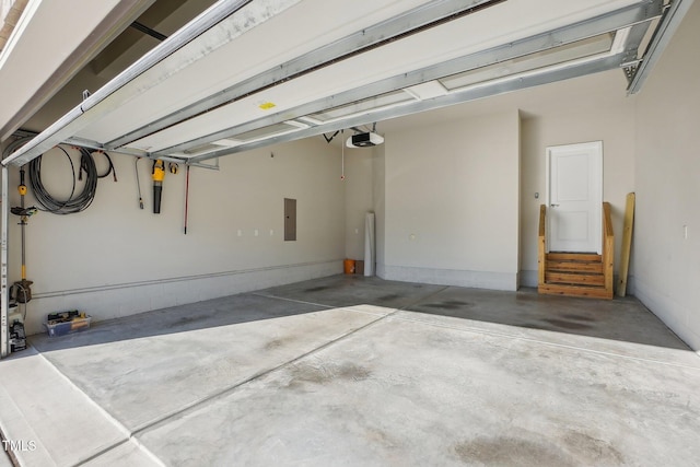 garage with electric panel and a garage door opener