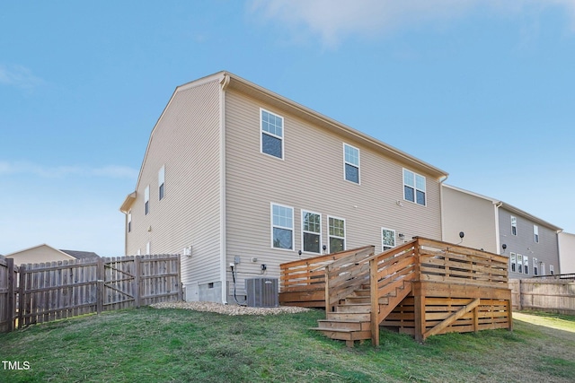 rear view of house featuring a lawn, a deck, a fenced backyard, cooling unit, and stairs