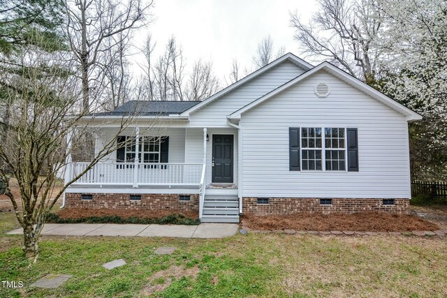 view of front of house with crawl space, a porch, a front lawn, and roof with shingles