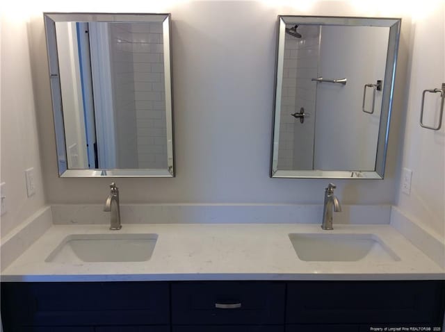 full bathroom featuring double vanity and a sink