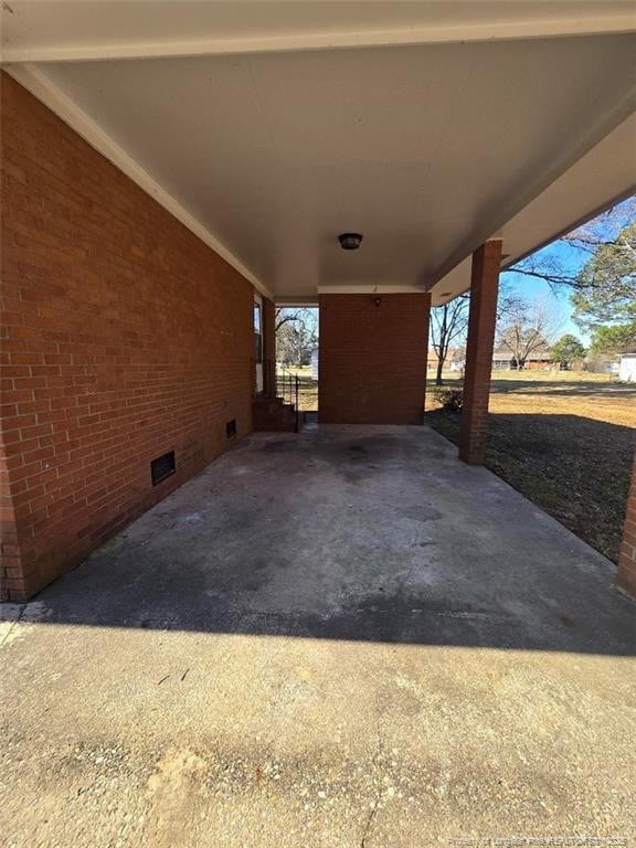 view of patio featuring a carport and driveway