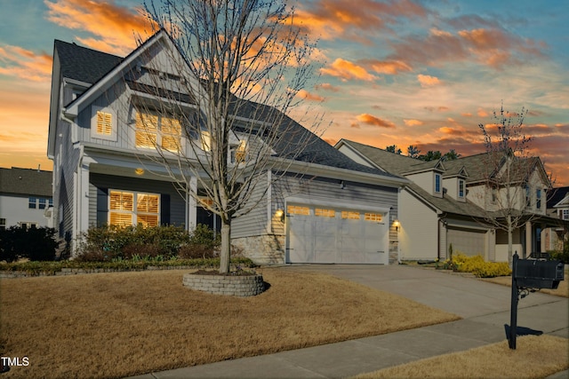 view of front of house featuring concrete driveway, a garage, board and batten siding, and stone siding