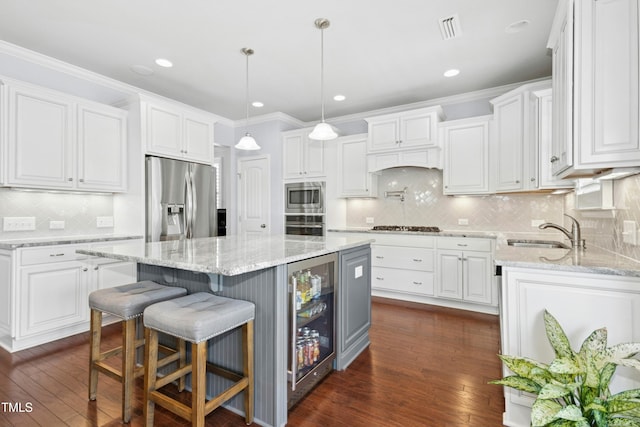 kitchen with beverage cooler, visible vents, a sink, stainless steel appliances, and white cabinetry