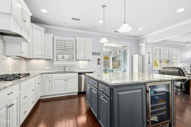 kitchen featuring gray cabinetry, beverage cooler, appliances with stainless steel finishes, white cabinets, and a sink